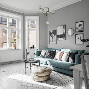 دکوراسیون طوسی و سفید نشمین با دیوارهای خاکستری و مبل سبز