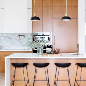 کابینت سفید و رنگ چوب روشن مات در آشپزخانه مدرن جزیره دار بزرگ با بین کابینتی مرمر سفید